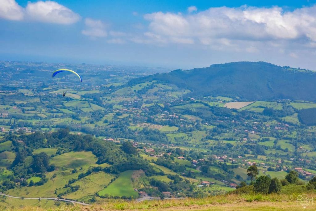 Green mountains of Asturias with a paraglider