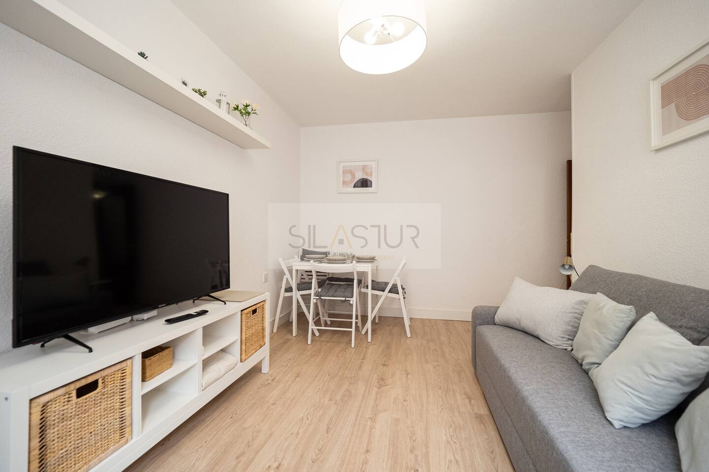Living room with sofa, TV and dining area