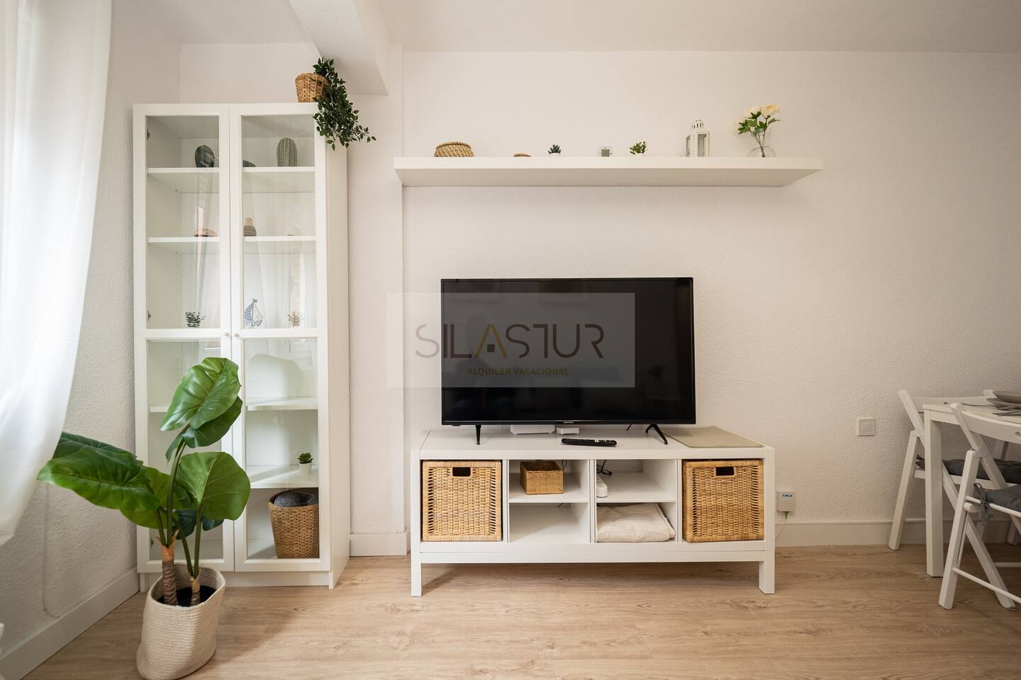 Living room with TV, storage unit and shelving