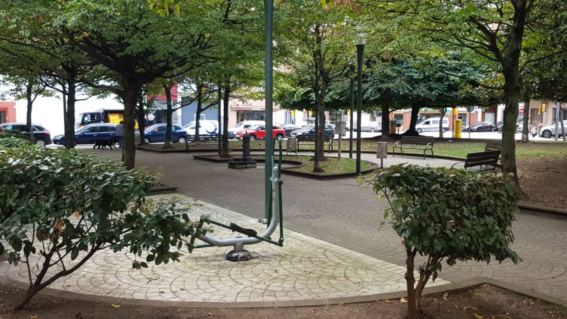 Tree-lined square with outdoor exercise equipment